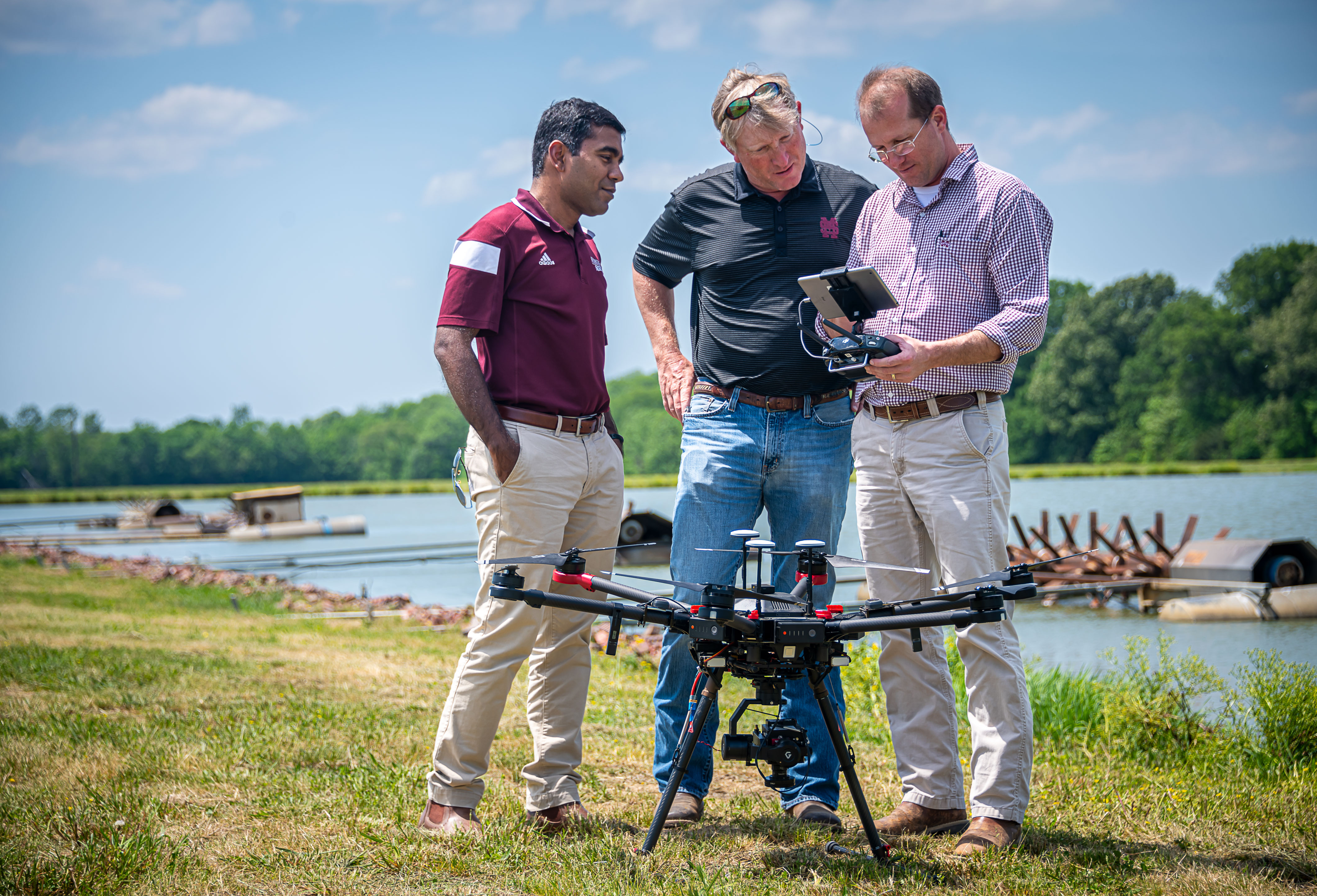 Drs. Satish Samiappan, Wes Lowe, and Gray Turnage review hyperspectral images of catfish ponds to determine the presence of cyanobacteria. (Photo by David Ammon)