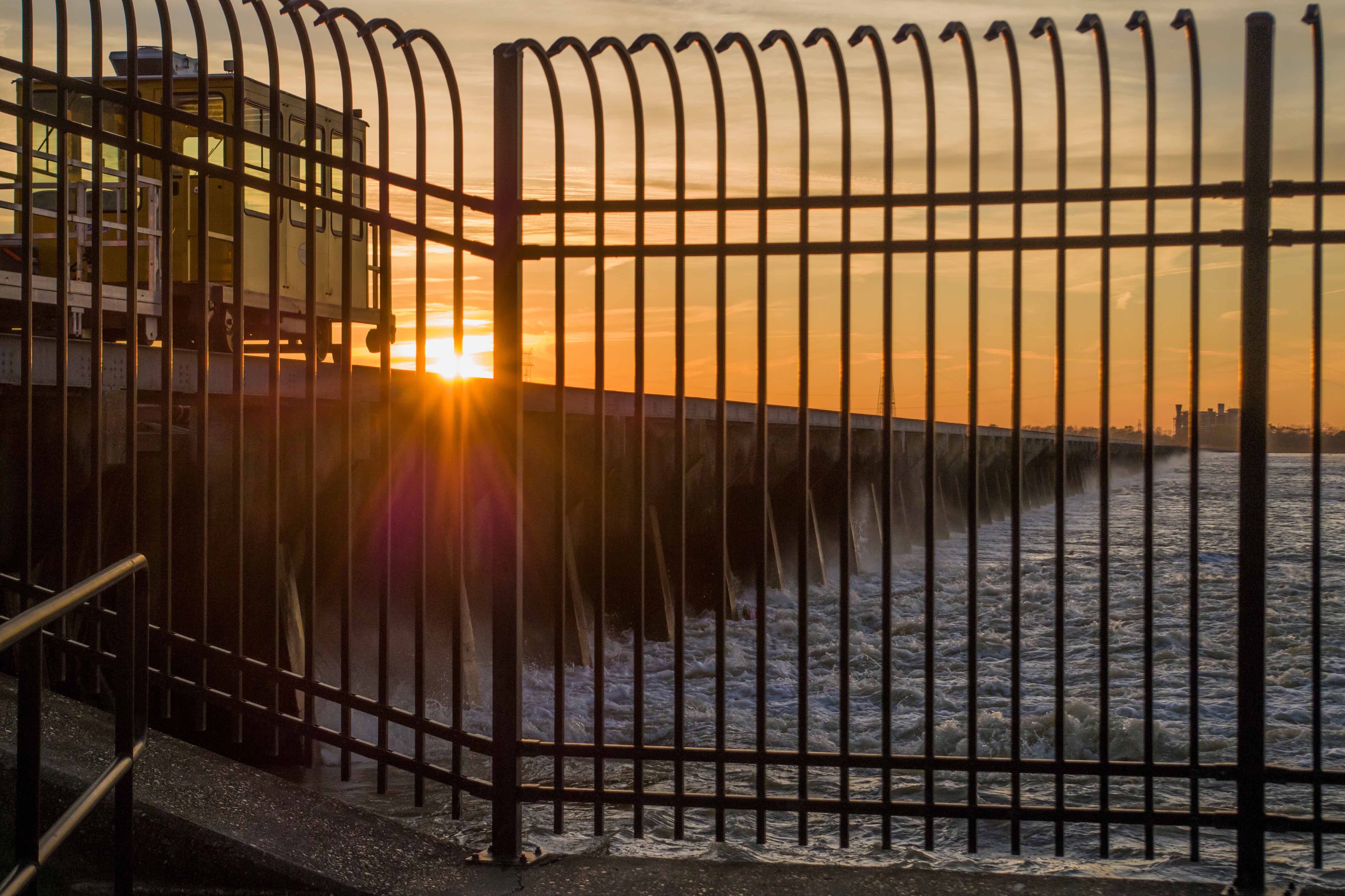 The Bonne Carré  Spillway diverts water at sunset during a high Mississippi River flood stage